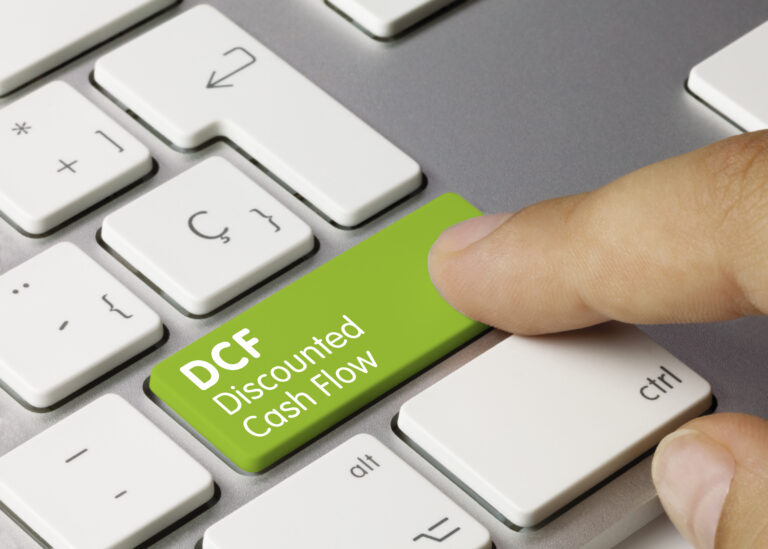 DCF Discounted Cash Flow Written on Green Key of Metallic Keyboard. Finger pressing key.